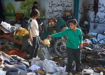 Niños buscan sus cosas entre los escombros de escuela bombardeada en Gaza